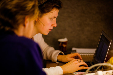 Girl and boy coding on a laptop